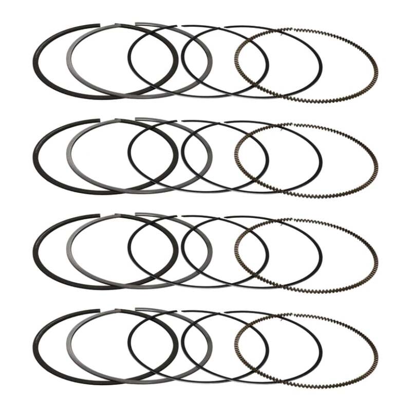 Four Manley piston ring sets laid out, one set per cylinder (product illustration)