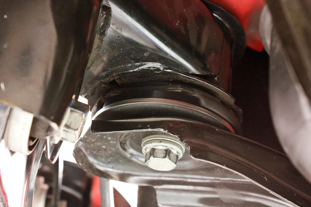 BMR BK063 Delrin lockout fitted to a Camaro Gen 6 front cradle bushing - installed view
