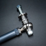 Suspension Secrets grey tie rod end, rod end and shim stack close-up on a dark background - Suspension Secrets Thumbnail