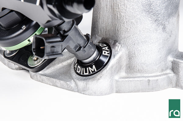 Radium 27mm injector seat installed in a Subaru intake manifold with a top feed injector