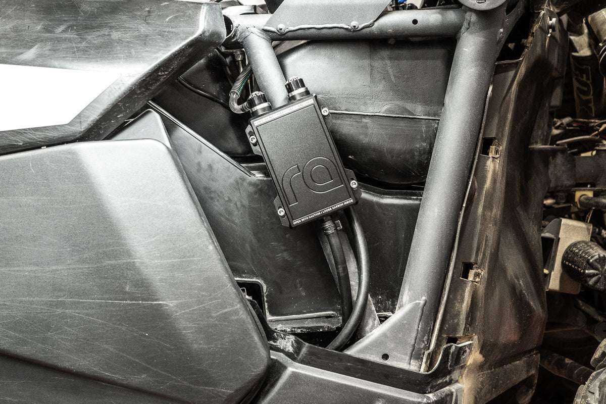 Radium charcoal canister mounted to the frame behind the front RH guard on a Can-Am Maverick