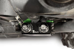 Radium charcoal canister top ports with low-profile barbed fittings on a Can-Am Maverick - Radium Off Road Thumbnail