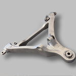 Factory lower wishbone shown with Suspension Secrets monoballs pressed in, angled view - Suspension Secrets Thumbnail