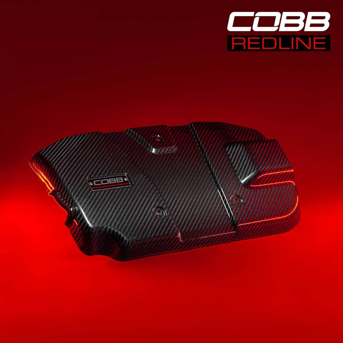 COBB Redline carbon fibre engine cover – Subaru WRX VB – cover on red backdrop