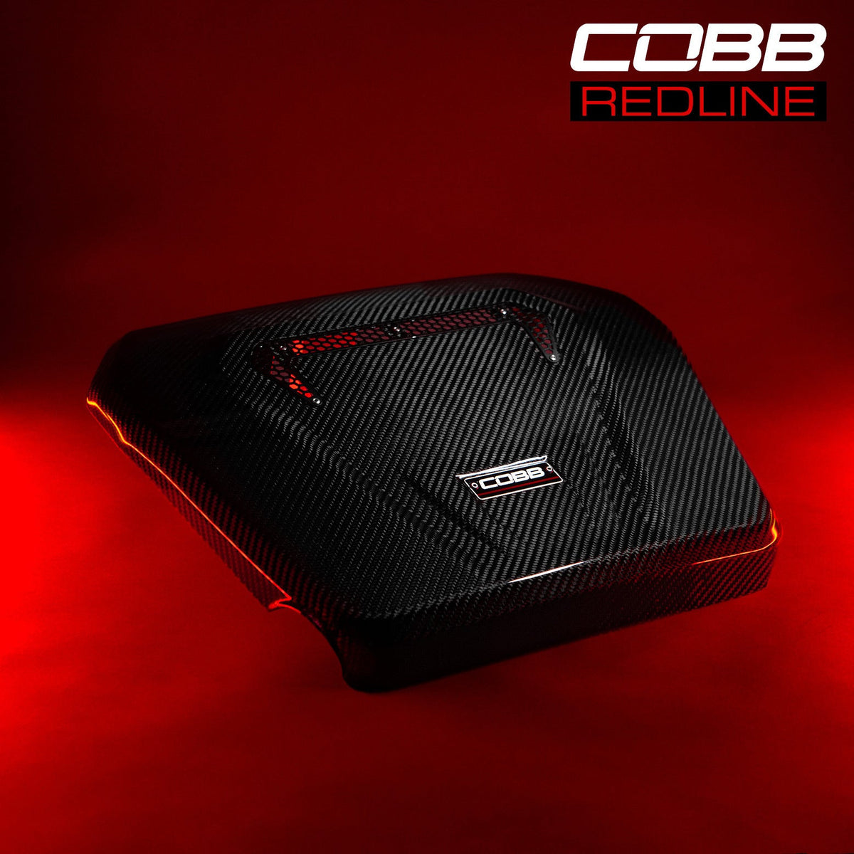 COBB Redline carbon fibre engine cover – Volkswagen Golf GTI and R – cover on a red-lit background