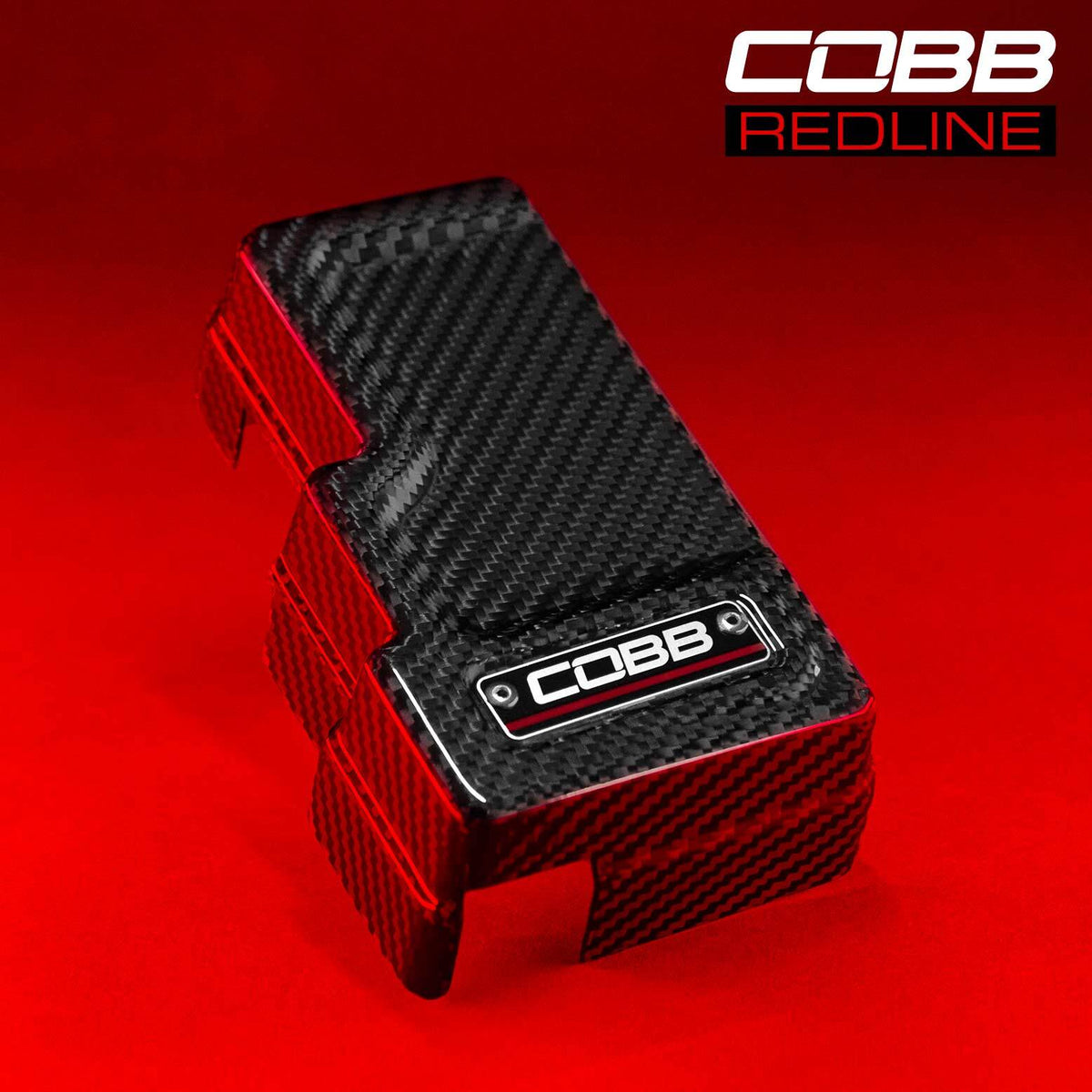 COBB Redline carbon fibre fuse cover – Subaru WRX VB – gloss cover with Redline badge on red background