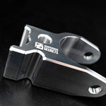 Suspension Secrets front camber block, close-up of the engraved logo on a dark background - Suspension Secrets Thumbnail