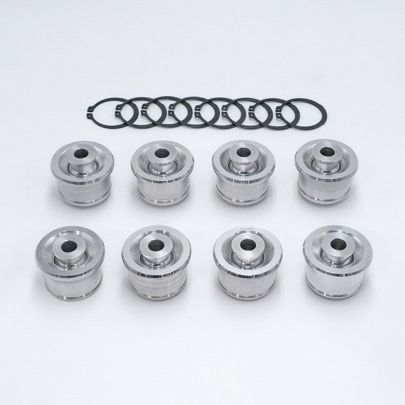 Suspension Secrets rear control arm monoball kit, eight bushes and eight circlips laid out - Suspension Secrets