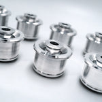 Suspension Secrets monoball bushes, group of machined aluminium bushes on a white background - Suspension Secrets Thumbnail