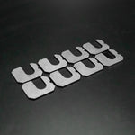 Suspension Secrets camber shims, set of eight laid out on a dark background - Suspension Secrets Thumbnail