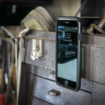 Scosche MagicMount flush mount – phone held on a steel toolbox (product illustration) - Cobb Tuning Thumbnail