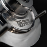 Suspension Secrets front top mount, close-up of the machined bearing housing and logo - Suspension Secrets Thumbnail