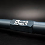 Suspension Secrets rear toe arm, close-up of the engraved logo on the adjuster body - Suspension Secrets Thumbnail