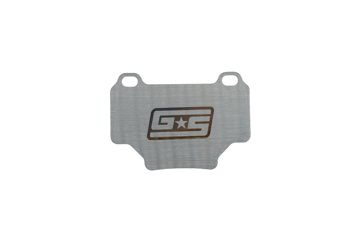 GrimmSpeed titanium rear brake shim for the WRX STI (VA) - front face with GS logo