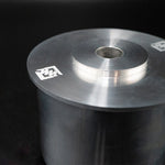 Suspension Secrets subframe bush, close-up of the flange and engraved logo on a dark background - Suspension Secrets Thumbnail