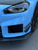 APR carbon canard pair on the other front bumper corner of a light blue BMW M2 G87 - APR Performance Thumbnail