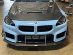 Light blue BMW M2 G87 front view with APR carbon canards on both front bumper corners - APR Performance Thumbnail