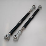 Pair of Suspension Secrets rear toe arms laid diagonally, showing the full length and logos - Suspension Secrets Thumbnail