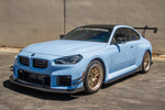 BMW M2 G87 with APR carbon air dam lip, front three-quarter view in a car park - APR Performance Thumbnail