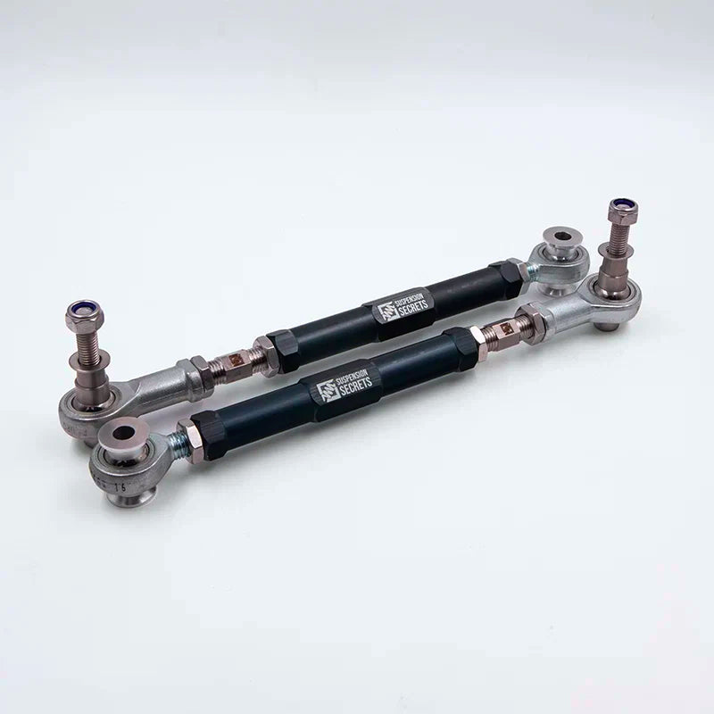 Suspension Secrets adjustable rear toe arms, pair with black bodies on a light grey background - Suspension Secrets