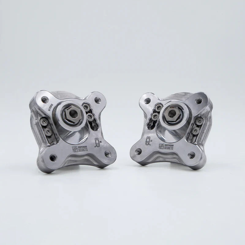 Suspension Secrets adjustable camber and caster plates, left and right pair on a white background - Suspension Secrets