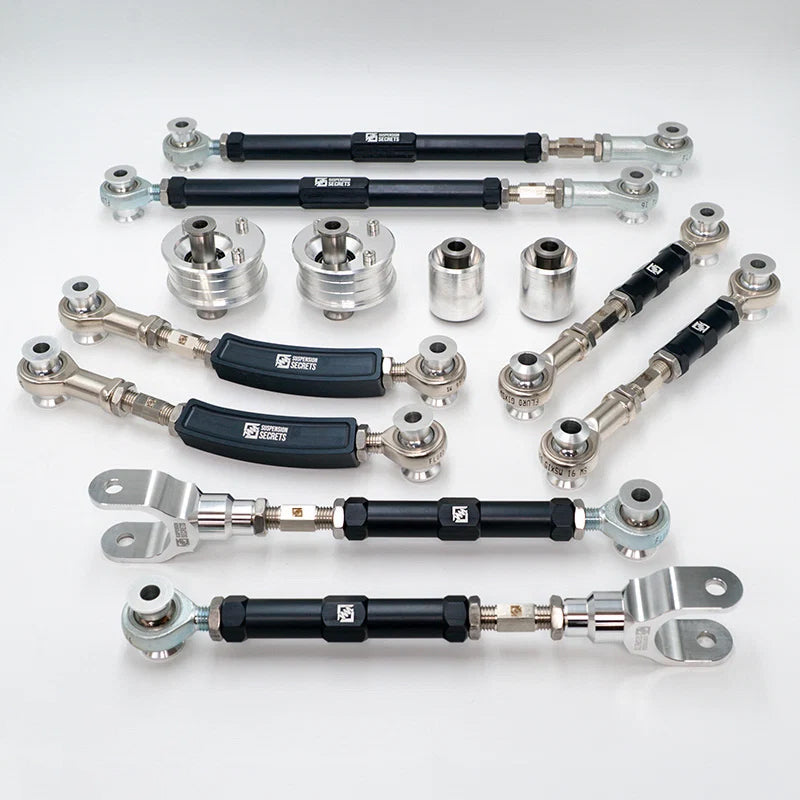 Suspension Secrets full kinematics kit, adjustable rear arms and bushes laid out - Suspension Secrets