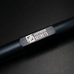 Suspension Secrets rear toe arm, close-up of the engraved logo on the black body - Suspension Secrets Thumbnail