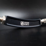 Suspension Secrets rear camber arm, close-up of the curved body and logo on a dark background - Suspension Secrets Thumbnail