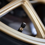 COBB aluminium valve stem caps – cap on valve stem close-up on a gold wheel - Cobb Tuning Thumbnail
