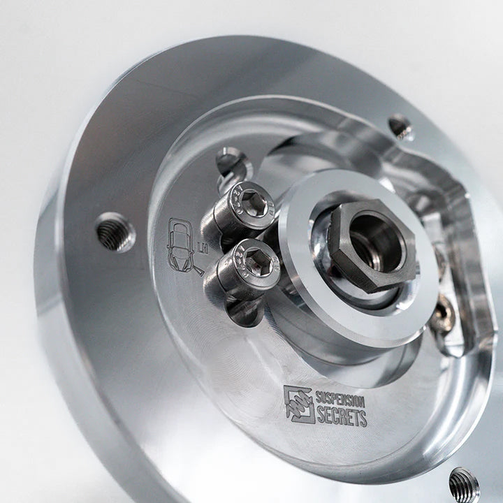 Suspension Secrets top nut fitted in the centre bearing of a camber plate, close-up - Suspension Secrets