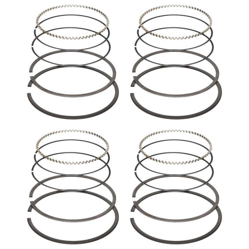 Four Manley 87.5 mm piston ring sets stacked, one set per cylinder