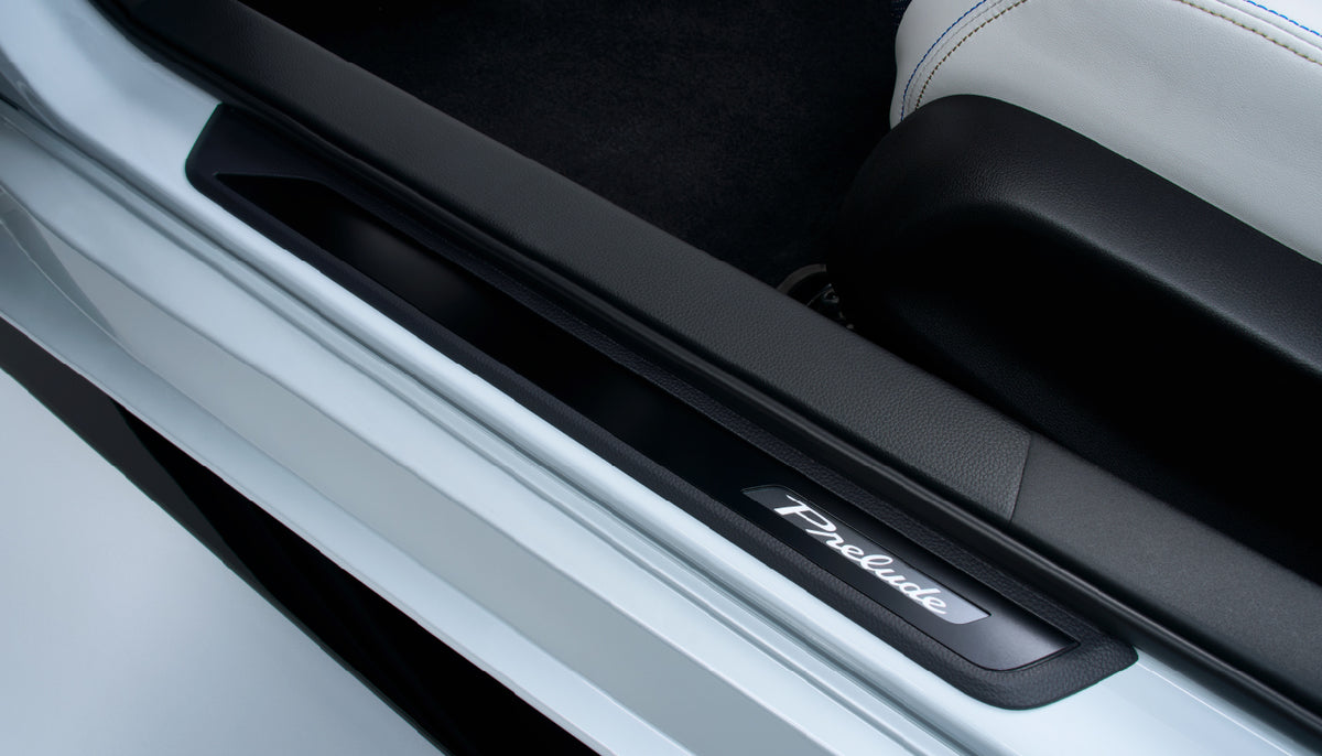 Black aluminium side step garnish on the door sill of a white Honda Prelude BF1