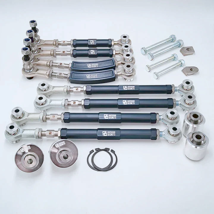 Suspension Secrets Full Kinematics Kit laid out: camber, toe and traction arms, lockout hardware and bushes - Suspension Secrets