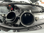 MST silicone turbo inlet beside the factory inlet in a BMW G-series B58 engine bay - MST Performance Thumbnail