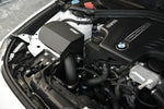 MST heat shield cover and intake pipe fitted beside the N20 engine in a white BMW - MST Performance Thumbnail
