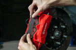 PRL titanium shim being fitted to a Civic Type R front Brembo caliper - PRL Motorsports Thumbnail