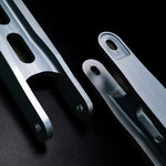 Suspension Secrets billet traction arm beside a factory folded plate arm - Suspension Secrets Thumbnail