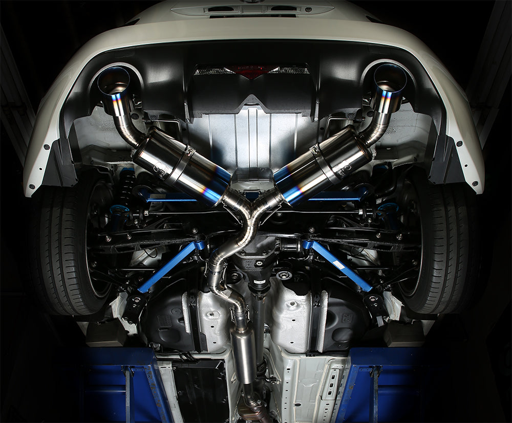 Tomei Ti RACING dual titanium muffler under a Toyota 86, splitting to a silencer each side after the diff