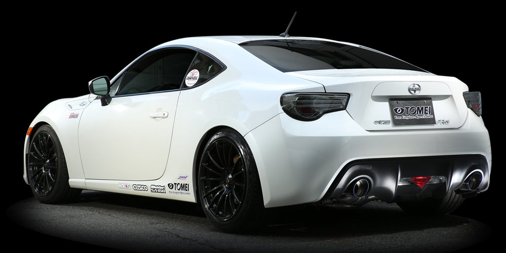 White Toyota 86 rear three-quarter view with the Tomei Ti RACING dual-exit titanium muffler fitted
